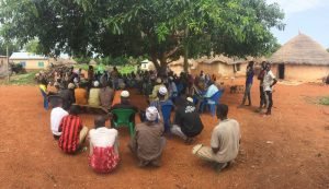 Farmers from all over my community of Jerigu coming to hear from the Director of Governance at USAID discussing the implementation of the "PICS" (Purdue Improved Crops Storage) project that will begin over the next 2 weeks in Jerigu to help with prolonged storage of crops with a select number of farmers in my community. 